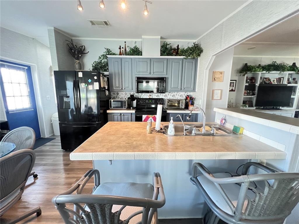 10100 Burnt Store Road, Unit 27 Punta Gorda, FL 33950 - Photo 15 of 37 a room with furniture and a flat screen tv