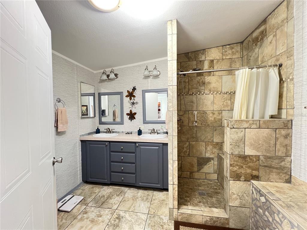 10100 Burnt Store Road, Unit 27 Punta Gorda, FL 33950 - Photo 20 of 37 a bath room with a sink and a mirror