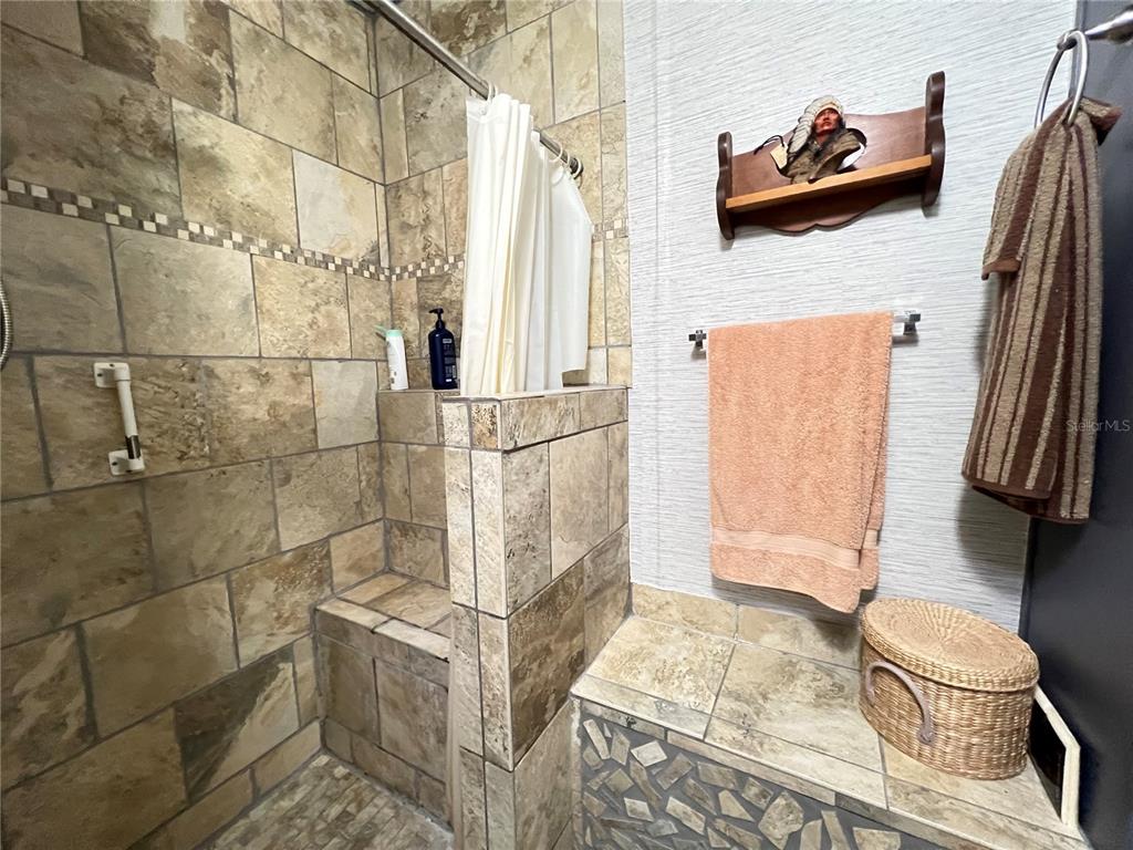 10100 Burnt Store Road, Unit 27 Punta Gorda, FL 33950 - Photo 23 of 37 a bathroom with a sink toilet and shower