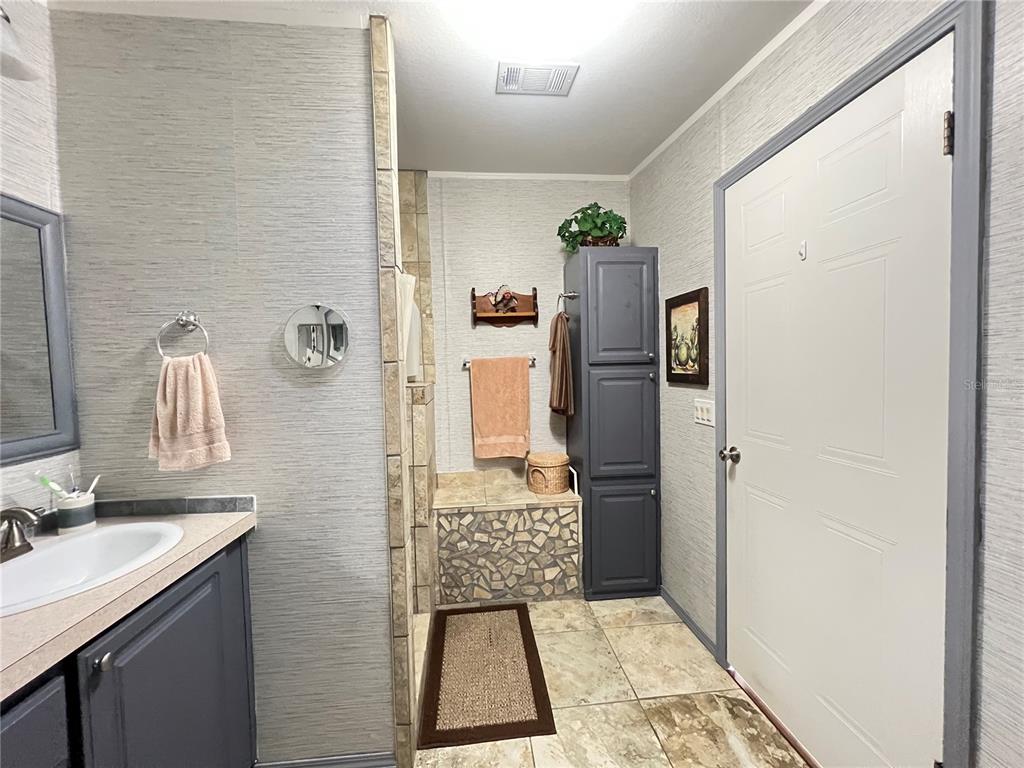 10100 Burnt Store Road, Unit 27 Punta Gorda, FL 33950 - Photo 25 of 37 a bathroom with a sink and a shower