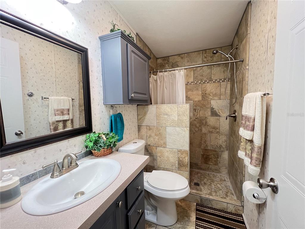 10100 Burnt Store Road, Unit 27 Punta Gorda, FL 33950 - Photo 28 of 37 a bathroom with a sink toilet and shower