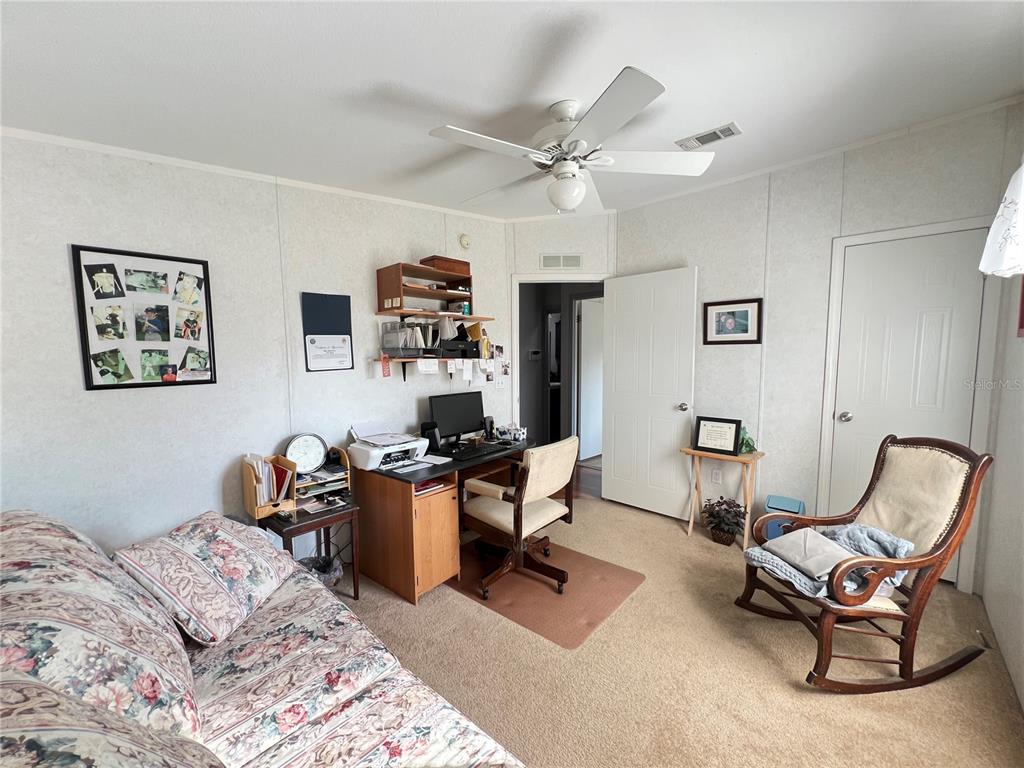 10100 Burnt Store Road, Unit 27 Punta Gorda, FL 33950 - Photo 29 of 37 a workspace with a couch and a window