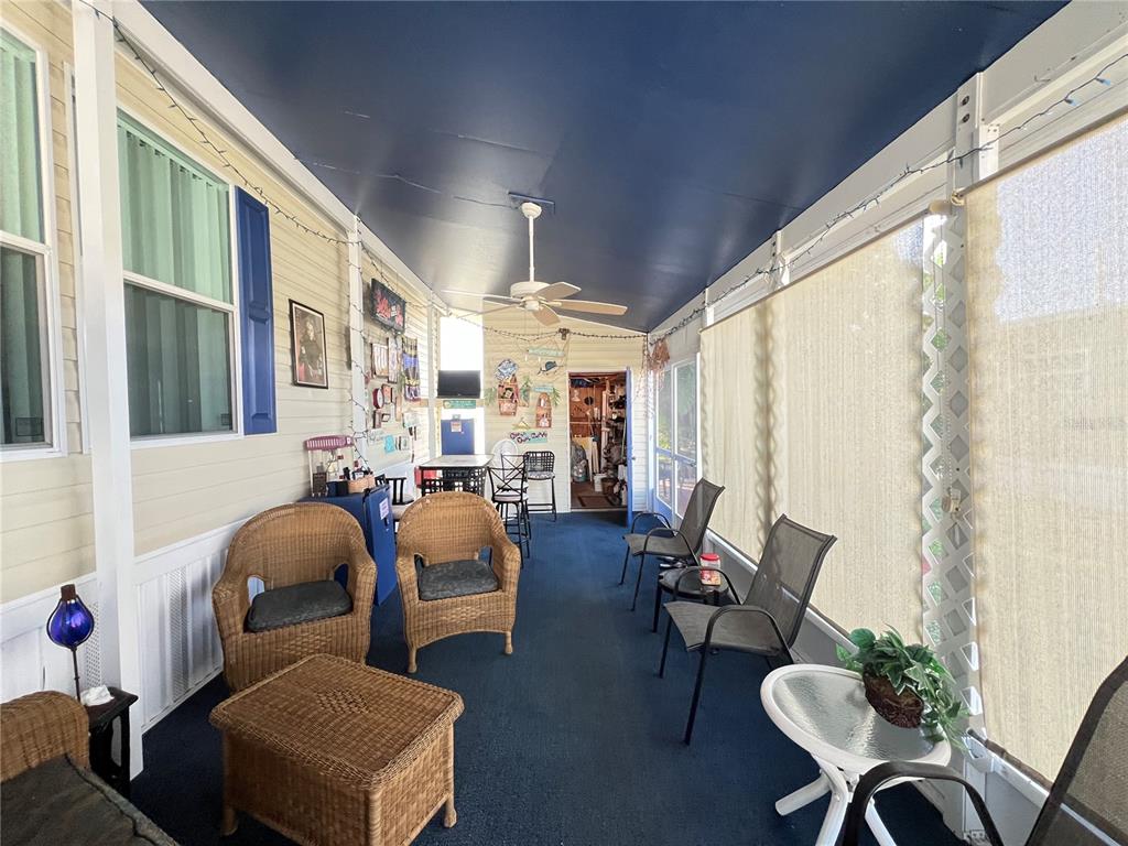 10100 Burnt Store Road, Unit 27 Punta Gorda, FL 33950 - Photo 32 of 37 a living room with furniture and a large window