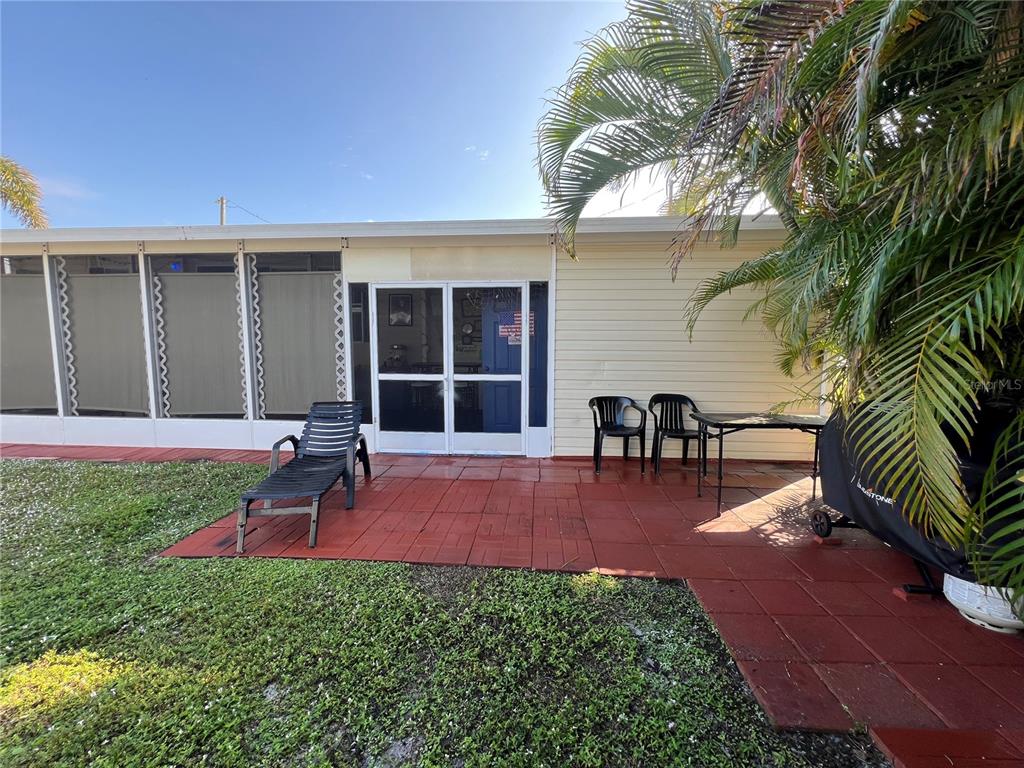 10100 Burnt Store Road, Unit 27 Punta Gorda, FL 33950 - Photo 36 of 37 a view of a backyard with a patio and a garden
