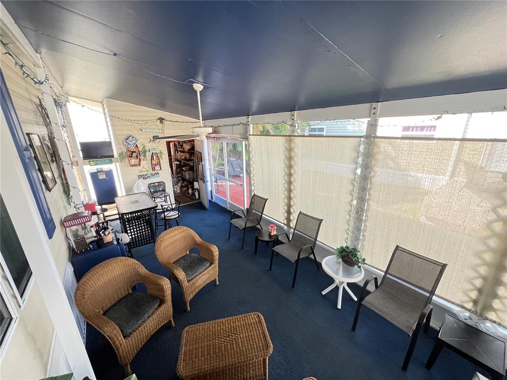 10100 Burnt Store Road, Unit 27 Punta Gorda, FL 33950 - Photo 4 of 37 a living room with furniture and a large window