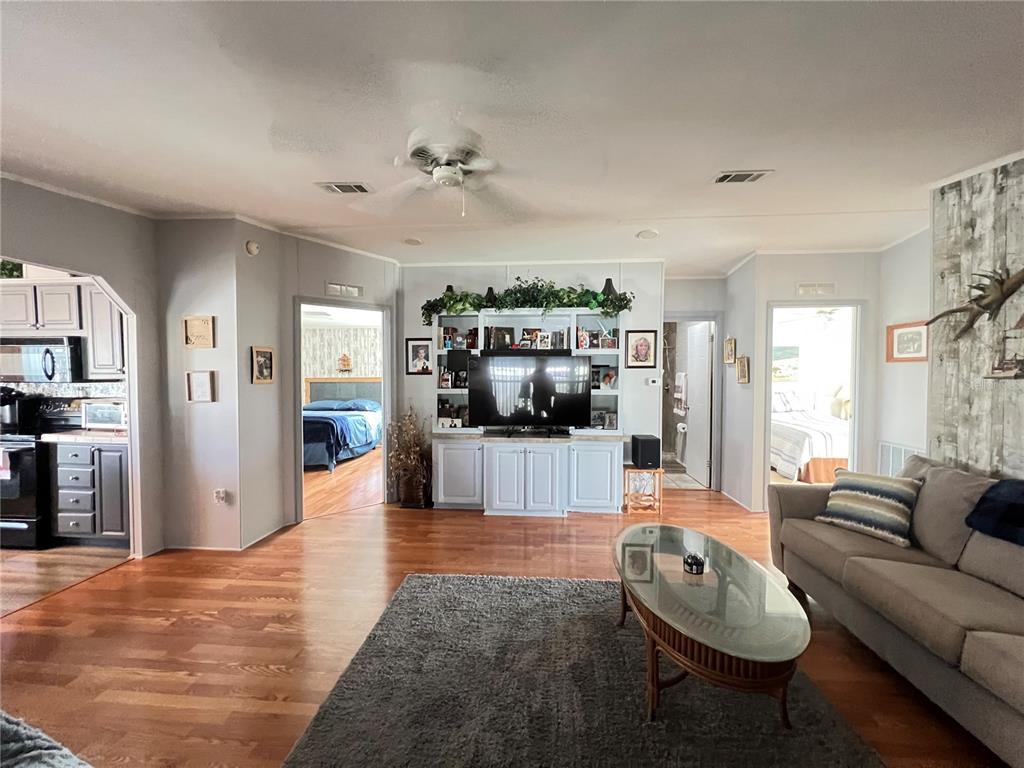 10100 Burnt Store Road, Unit 27 Punta Gorda, FL 33950 - Photo 6 of 37 a living room with furniture and a flat screen tv