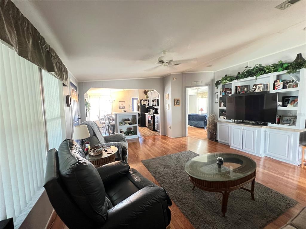 10100 Burnt Store Road, Unit 27 Punta Gorda, FL 33950 - Photo 10 of 37 a living room with furniture and a flat screen tv