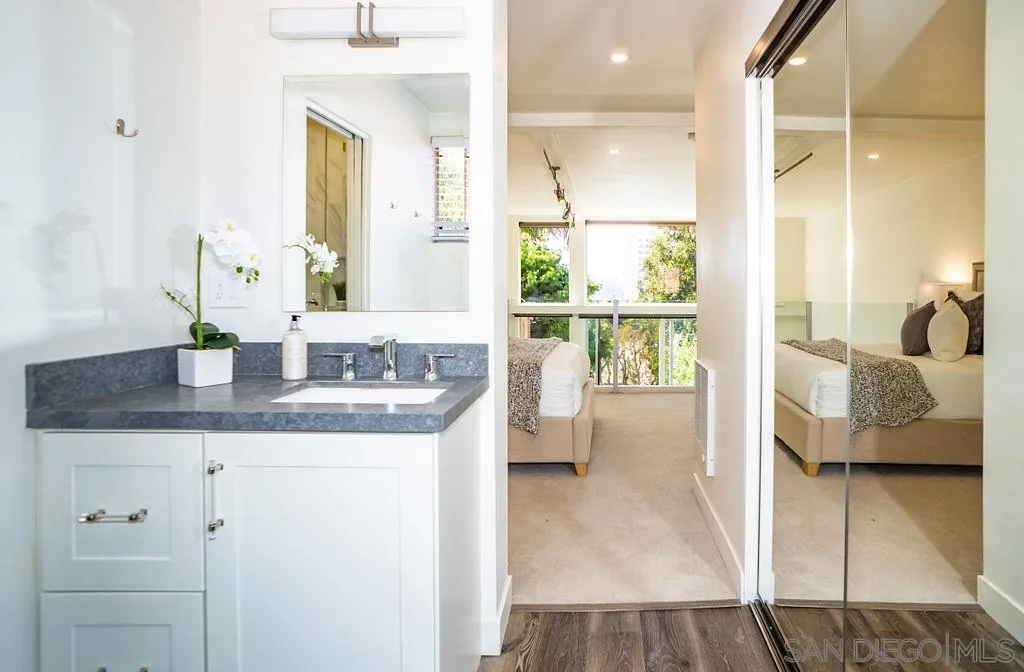 2630 Torrey Pines Road, Unit E22 La Jolla, CA 92037 - Photo 26 of 37 a en suite bathroom with a granite countertop sink and a mirror