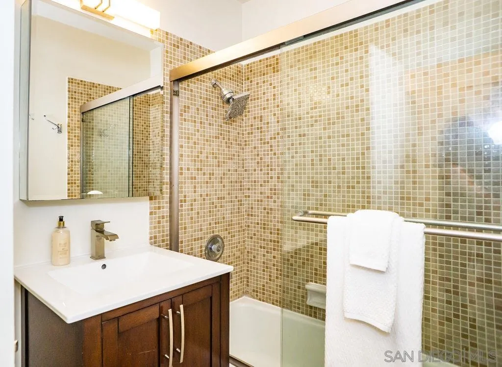 2630 Torrey Pines Road, Unit E22 La Jolla, CA 92037 - Photo 32 of 37 a bathroom with a sink and a mirror