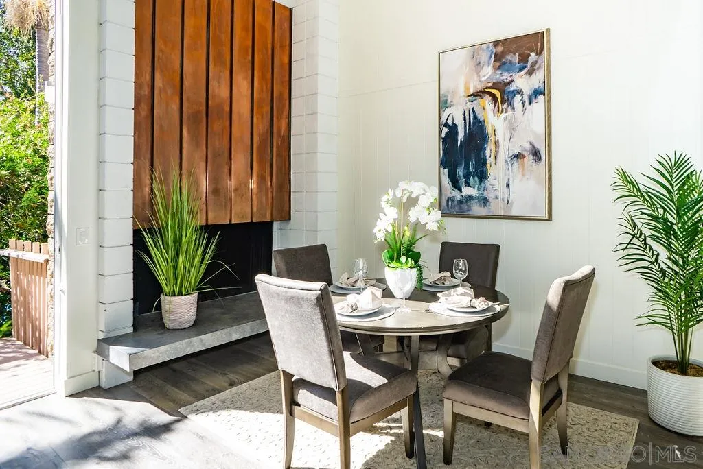 2630 Torrey Pines Road, Unit E22 La Jolla, CA 92037 - Photo 7 of 37 a dining room with furniture potted plants and wooden floor