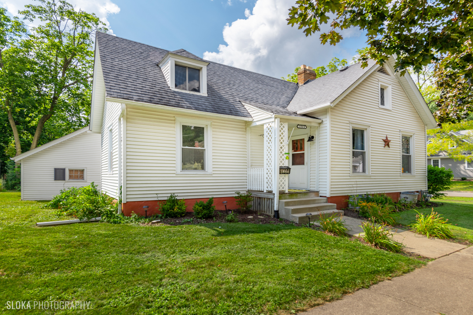 1044 Prospect Street Elgin, IL 60120 - Photo 1 of 21 a front view of a house with a yard