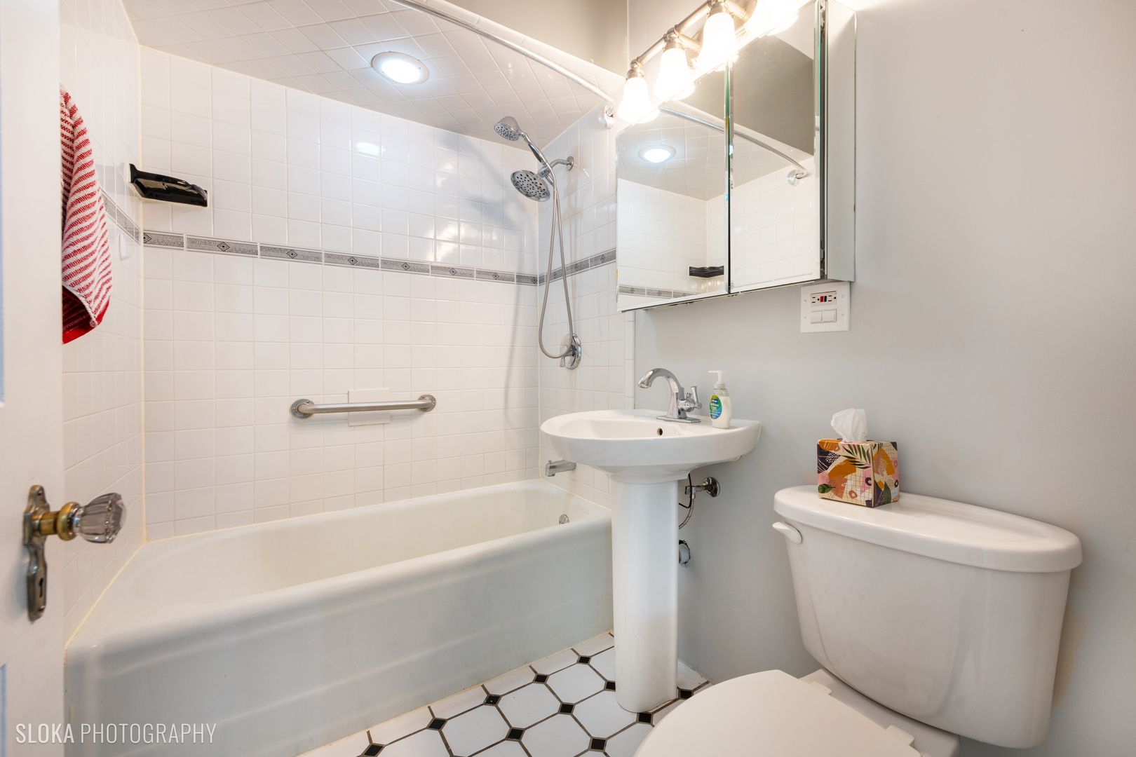 1044 Prospect Street Elgin, IL 60120 - Photo 12 of 21 a white toilet sitting next to a bathroom sink and tub