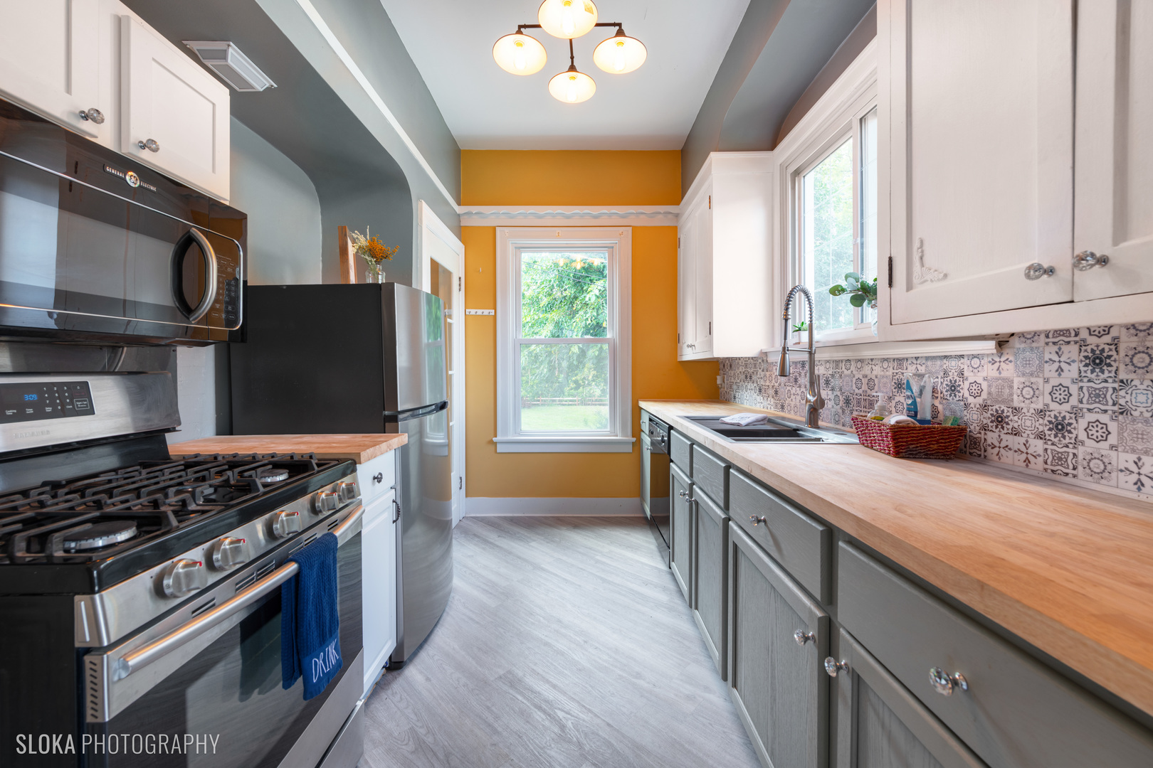 1044 Prospect Street Elgin, IL 60120 - Photo 14 of 21 a kitchen with stainless steel appliances granite countertop a sink stove and refrigerator