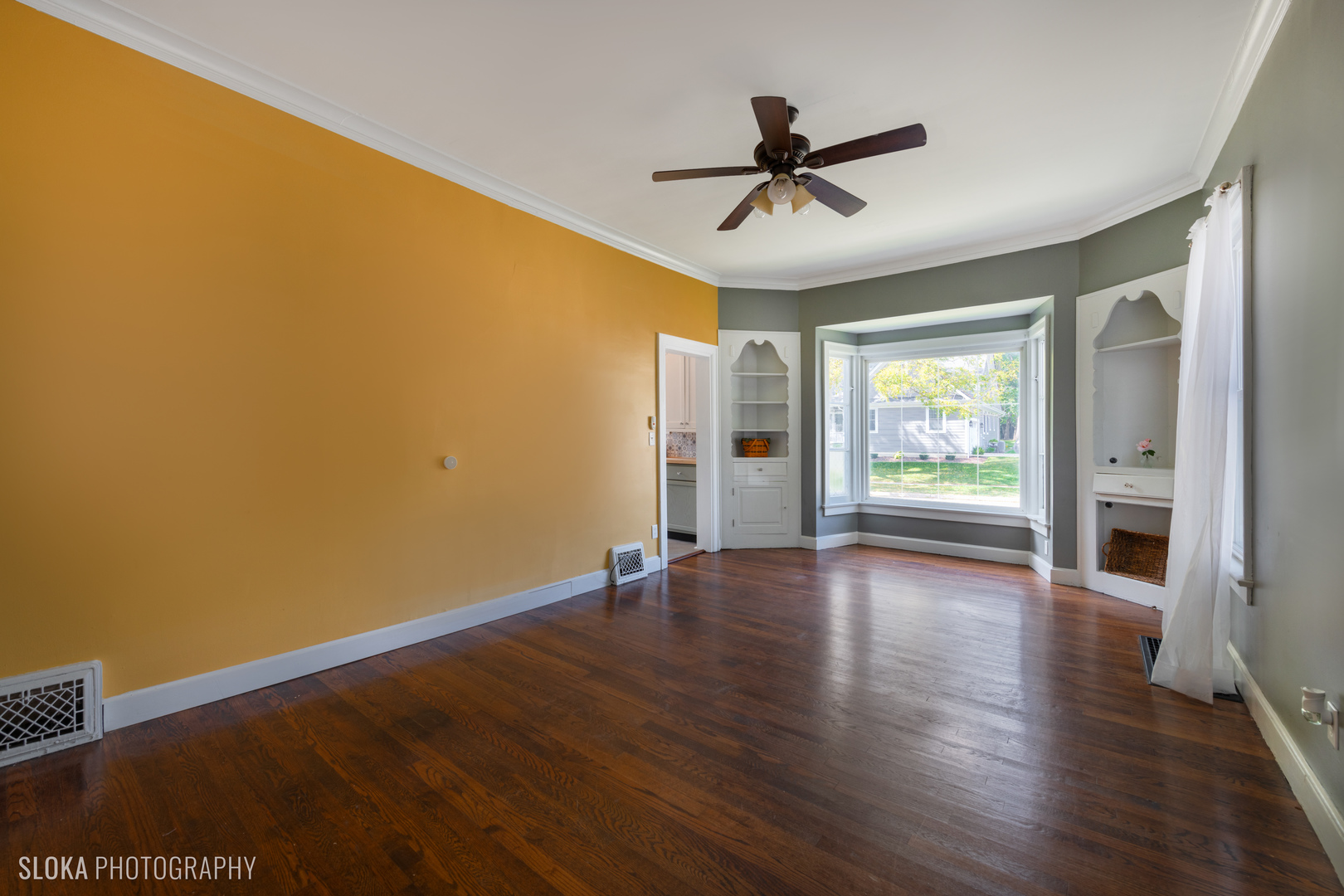 1044 Prospect Street Elgin, IL 60120 - Photo 5 of 21 a view of empty room with wooden floor and fan