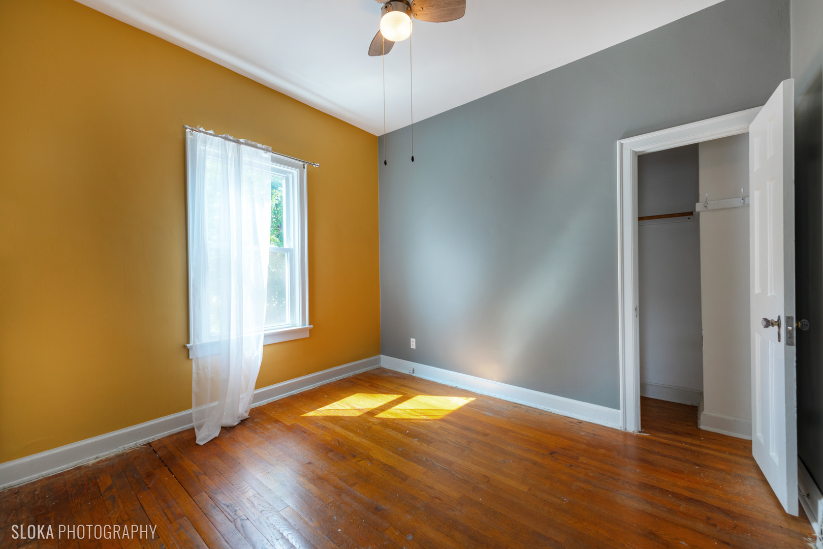 1044 Prospect Street Elgin, IL 60120 - Photo 8 of 21 an empty room with wooden floor and door