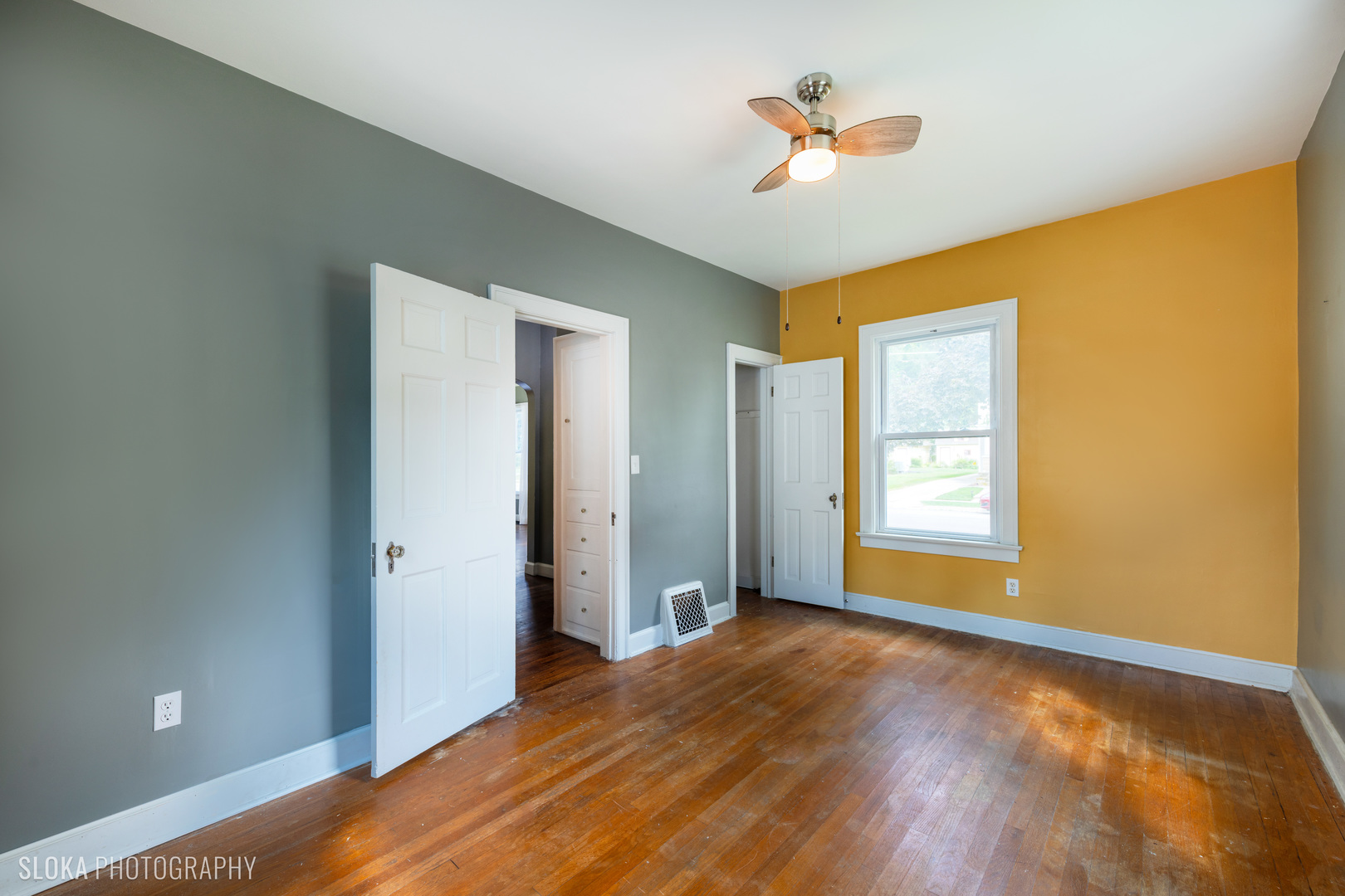 1044 Prospect Street Elgin, IL 60120 - Photo 9 of 21 a view of an empty room with window and a ceiling fan