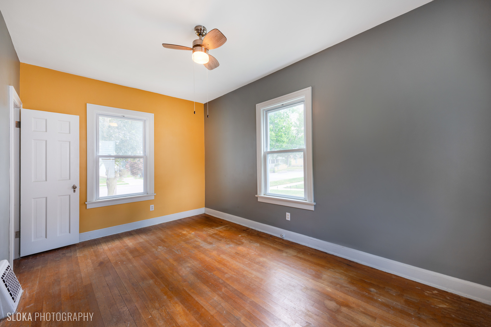 1044 Prospect Street Elgin, IL 60120 - Photo 10 of 21 a view of an empty room with a window and wooden floor