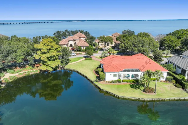 an aerial view of a house with a swimming pool patio and outdoor seating
