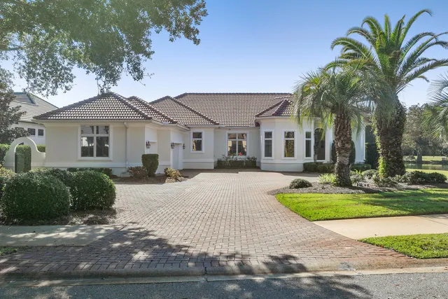 a bathroom with a sink double vanity granite tub shower and a mirror