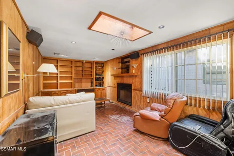 a living room with furniture a fireplace and a large window