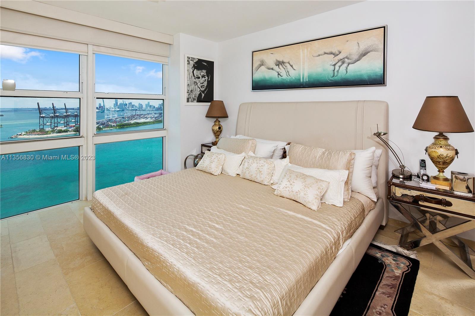 90 Alton Road, Unit 2906 Miami Beach, FL 33139 - Photo 2 of 6 a bedroom with a bed and a painting on the wall