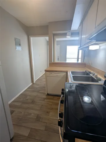 a view of a room with wooden floor