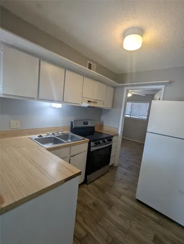 a kitchen with a stove and a refrigerator