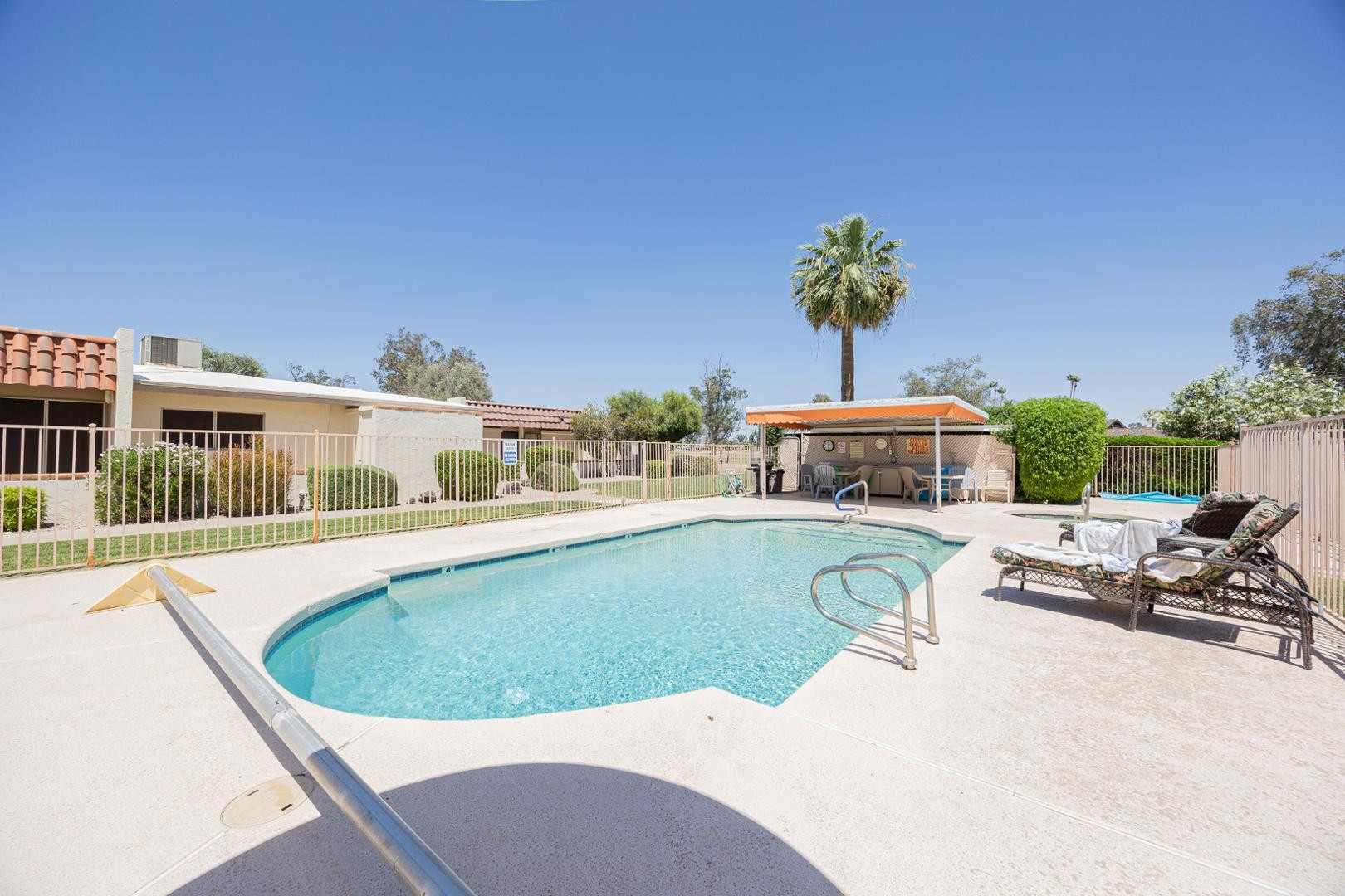 609 South Power Road, Unit 338 Mesa, AZ 85206 - Photo 24 of 24 a view of a swimming pool with a lounge chair