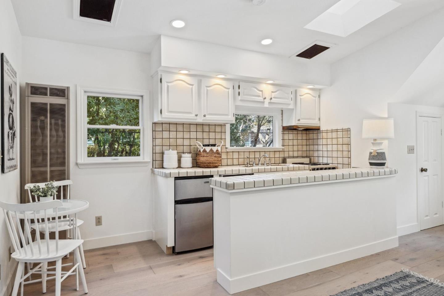 961 Berkeley Avenue Menlo Park, CA 94025 - Photo 23 of 27 a kitchen with kitchen island granite countertop a sink and a stove top oven