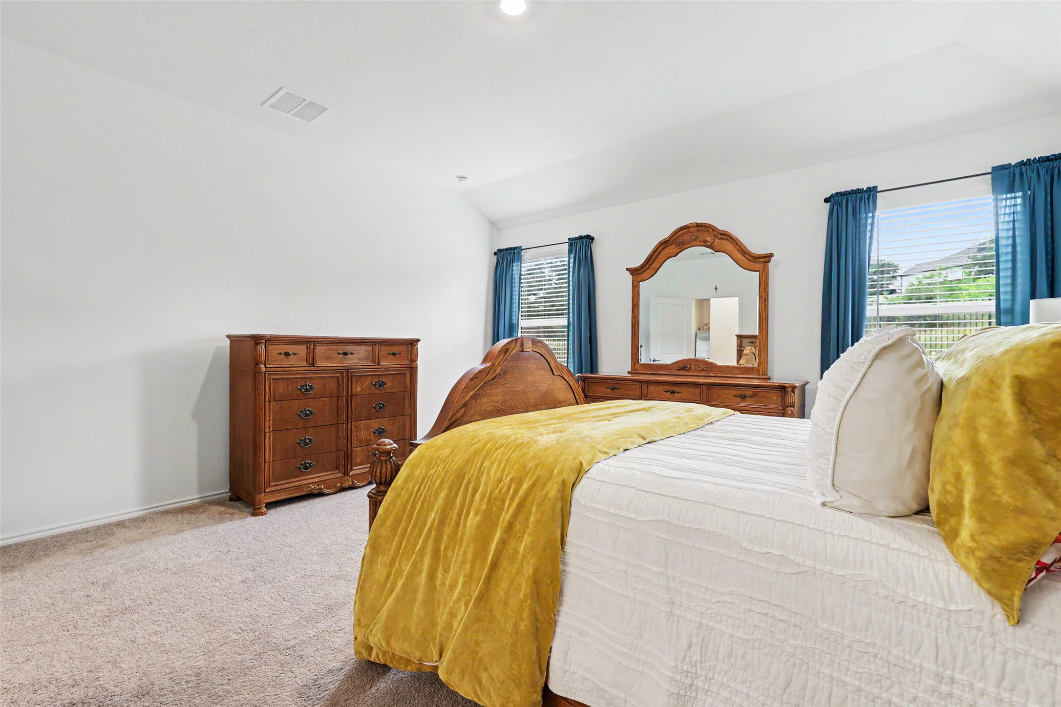 2333 Four Waters Loop Georgetown, TX 78628 - Photo 20 of 35 Spacious room featuring vaulted ceilings, light neutral wall paint, and light-tone carpeting