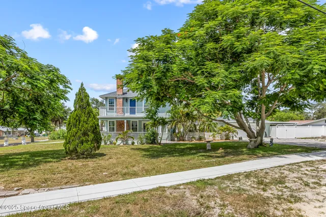 a view of a house with backyard porch and sitting area