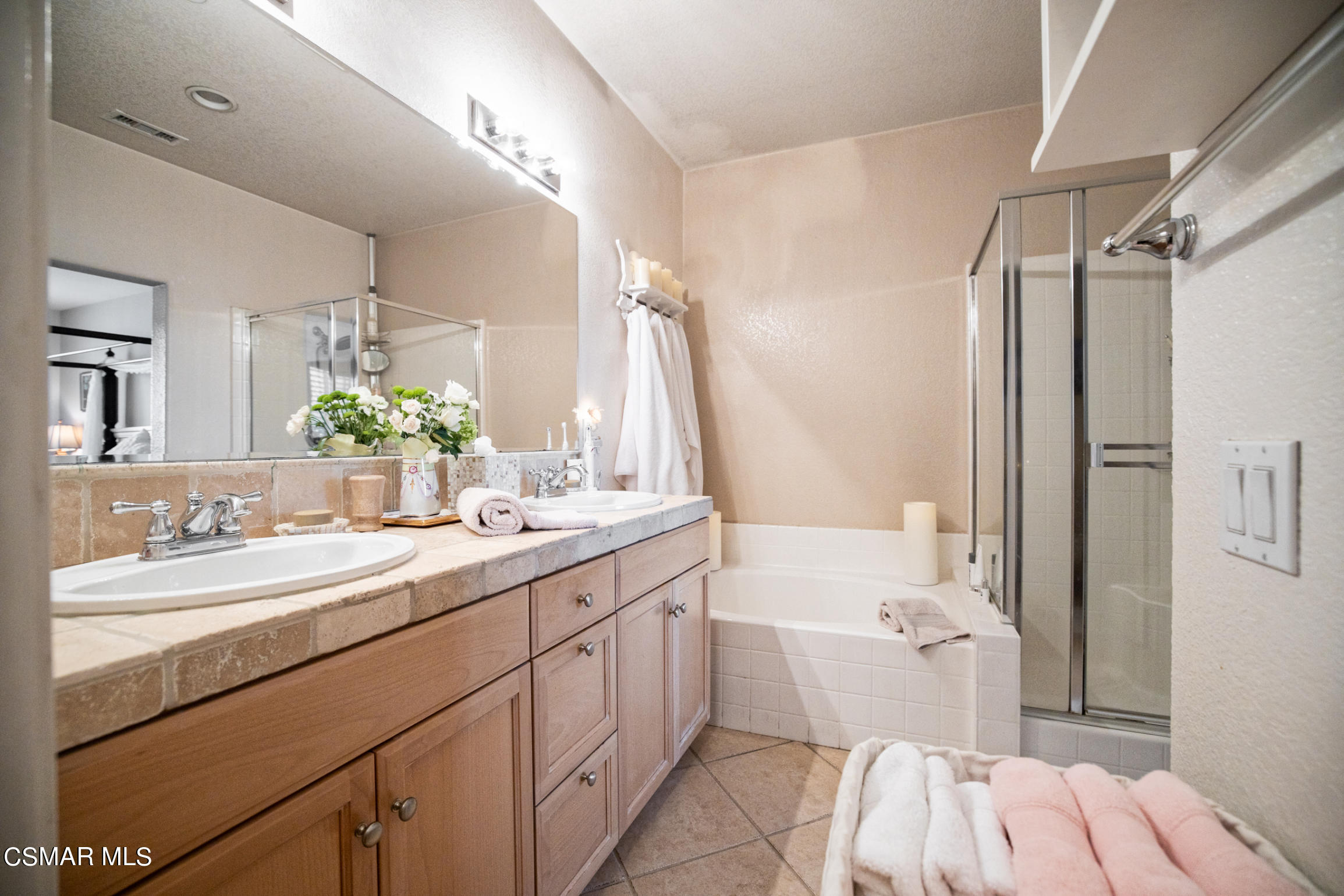 6825 Simmons Way Moorpark, CA 93021 - Photo 13 of 24 a bathroom with a sink double vanity mirror and a toilet