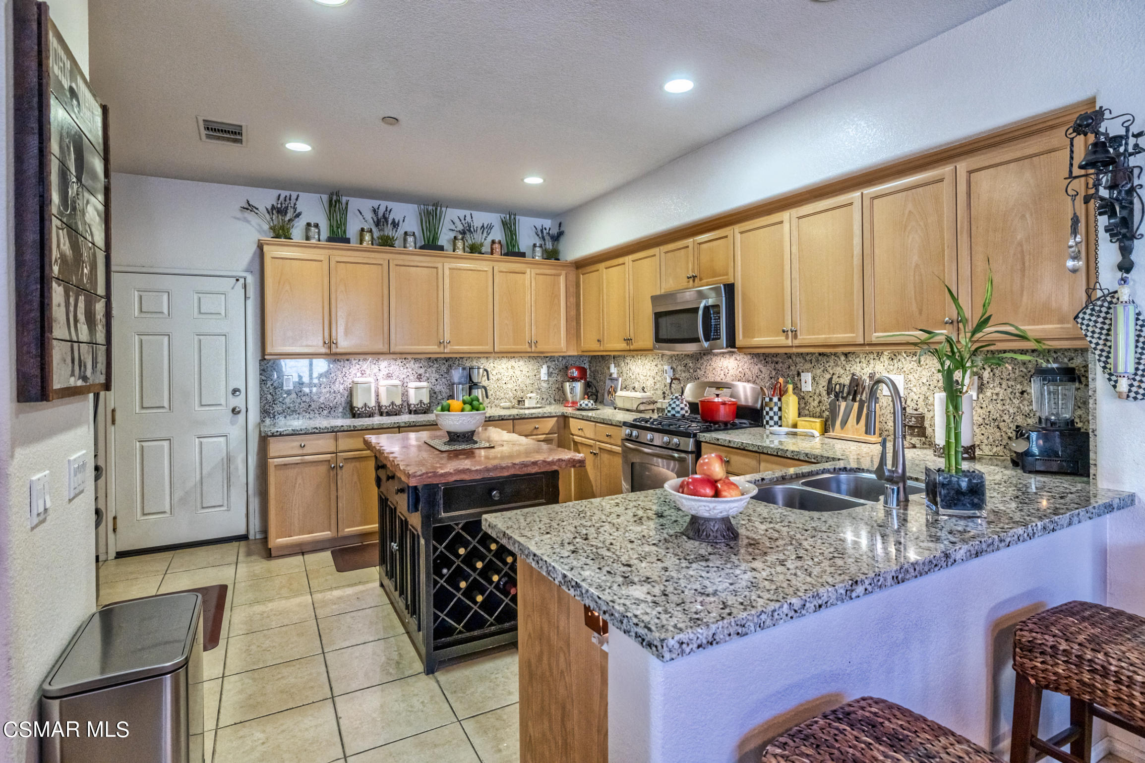 6825 Simmons Way Moorpark, CA 93021 - Photo 7 of 24 a kitchen with a sink stove and cabinets