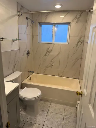 a bathroom with a toilet and a bathtub