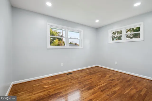 a view of room with window and wooden floor