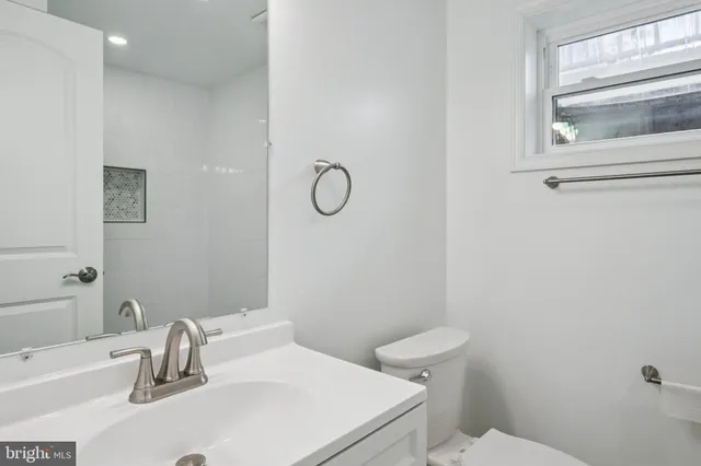 a bathroom with a sink toilet and tub