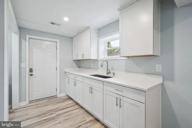 a kitchen with a sink cabinets and a window