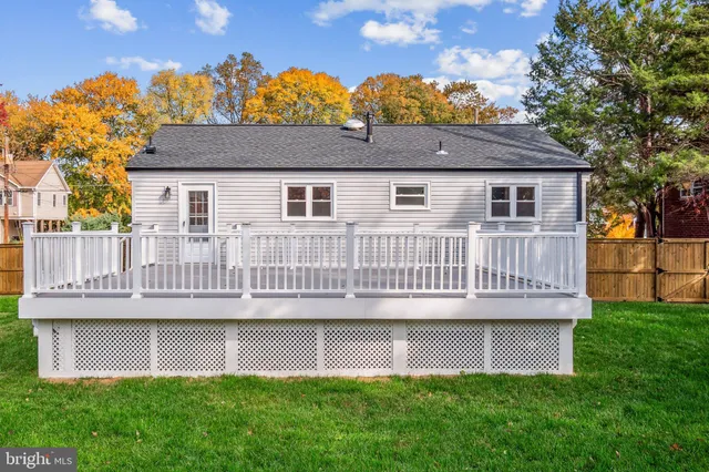 a view of a house with a deck and a yard