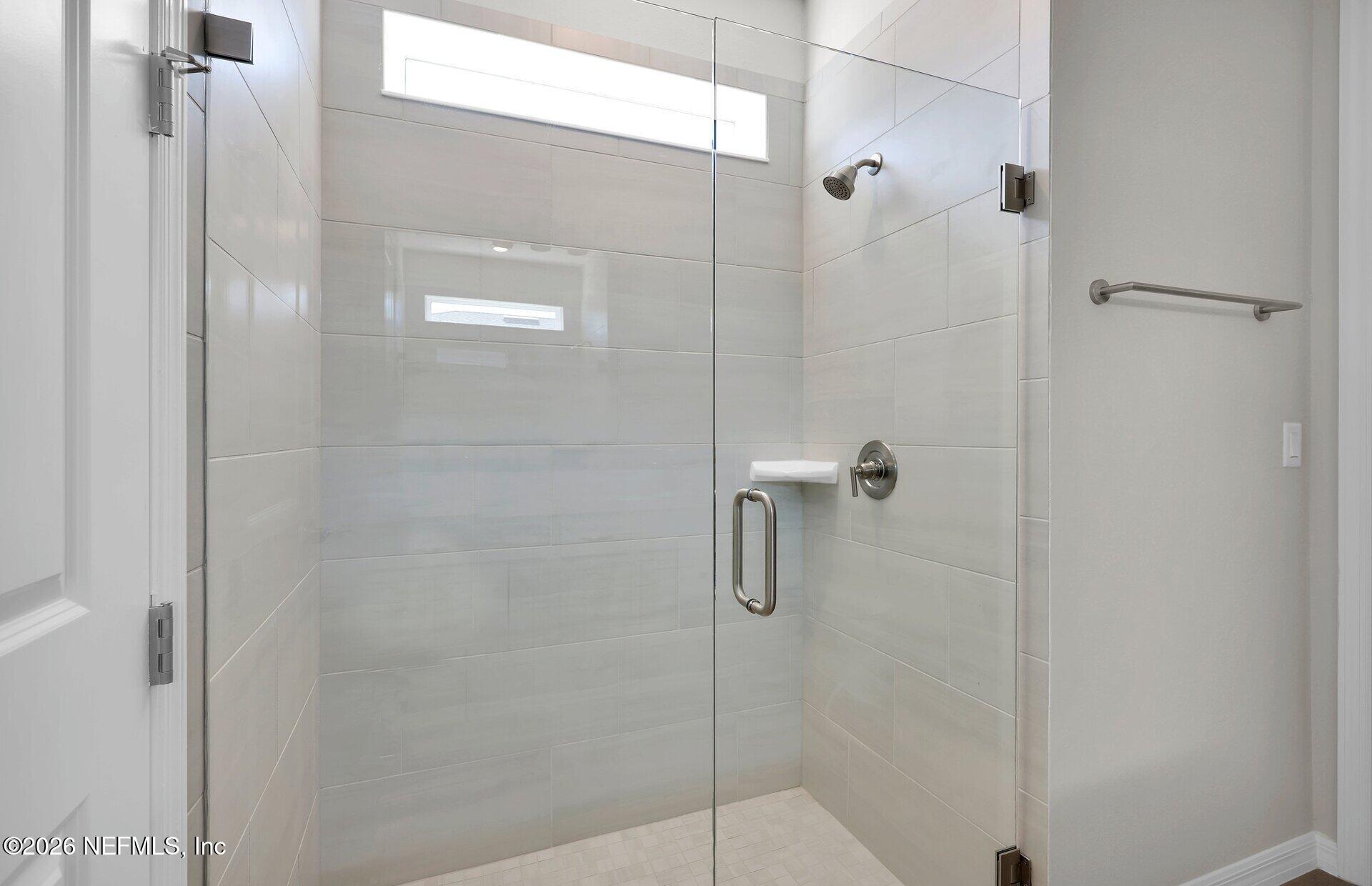 908 Rooster Hollow Way Middleburg, FL 32068 - Photo 16 of 26 a bathroom with a shower
