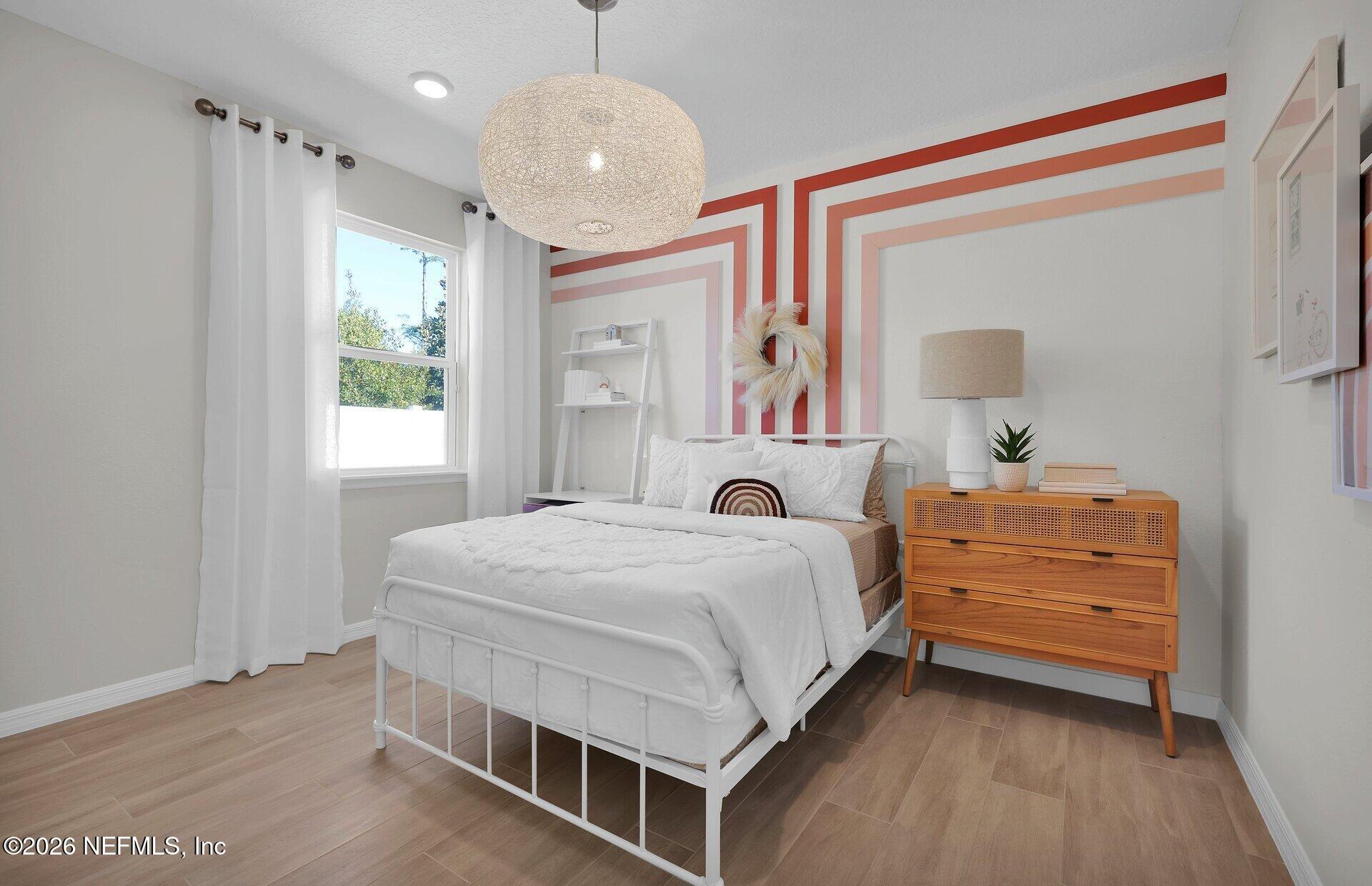 908 Rooster Hollow Way Middleburg, FL 32068 - Photo 18 of 26 a bedroom with a bed and a dresser