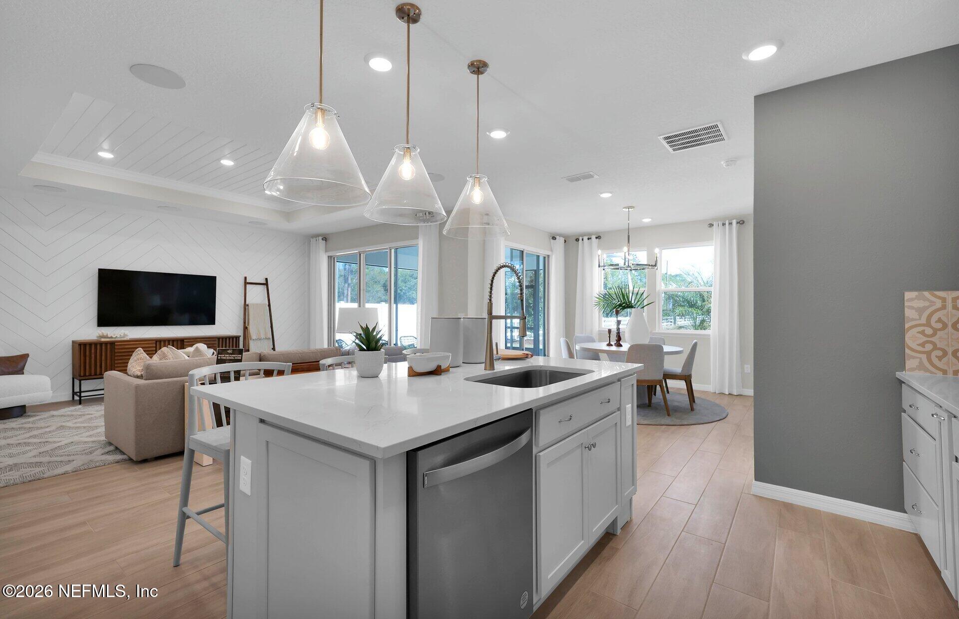 908 Rooster Hollow Way Middleburg, FL 32068 - Photo 7 of 26 a open kitchen with stainless steel appliances granite countertop a stove and a wooden floors