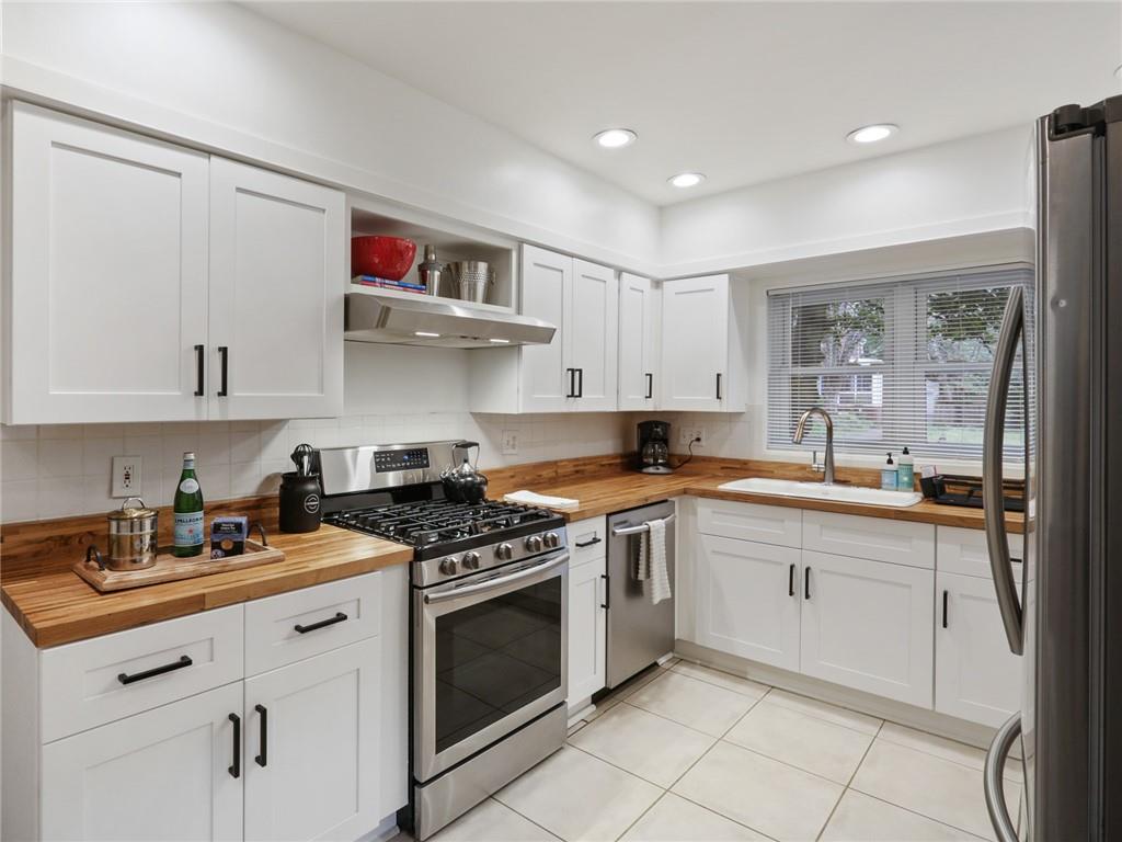 961 East Rock Springs Road Northeast, Unit MODERN Atlanta, GA 30306 - Photo 13 of 47 a kitchen with white cabinets stainless steel appliances and sink