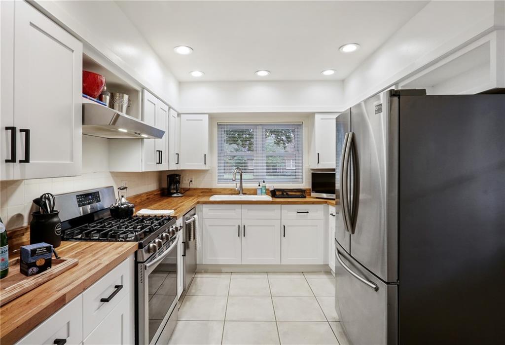 961 East Rock Springs Road Northeast, Unit MODERN Atlanta, GA 30306 - Photo 15 of 47 a kitchen with stainless steel appliances granite countertop a refrigerator and a sink