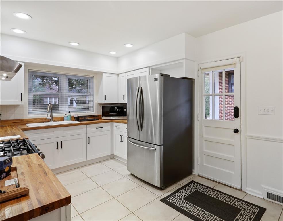 961 East Rock Springs Road Northeast, Unit MODERN Atlanta, GA 30306 - Photo 17 of 47 a kitchen with a refrigerator and cabinets