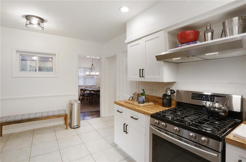 961 East Rock Springs Road Northeast, Unit MODERN Atlanta, GA 30306 - Photo 18 of 47 a kitchen with stainless steel appliances granite countertop a stove and a refrigerator