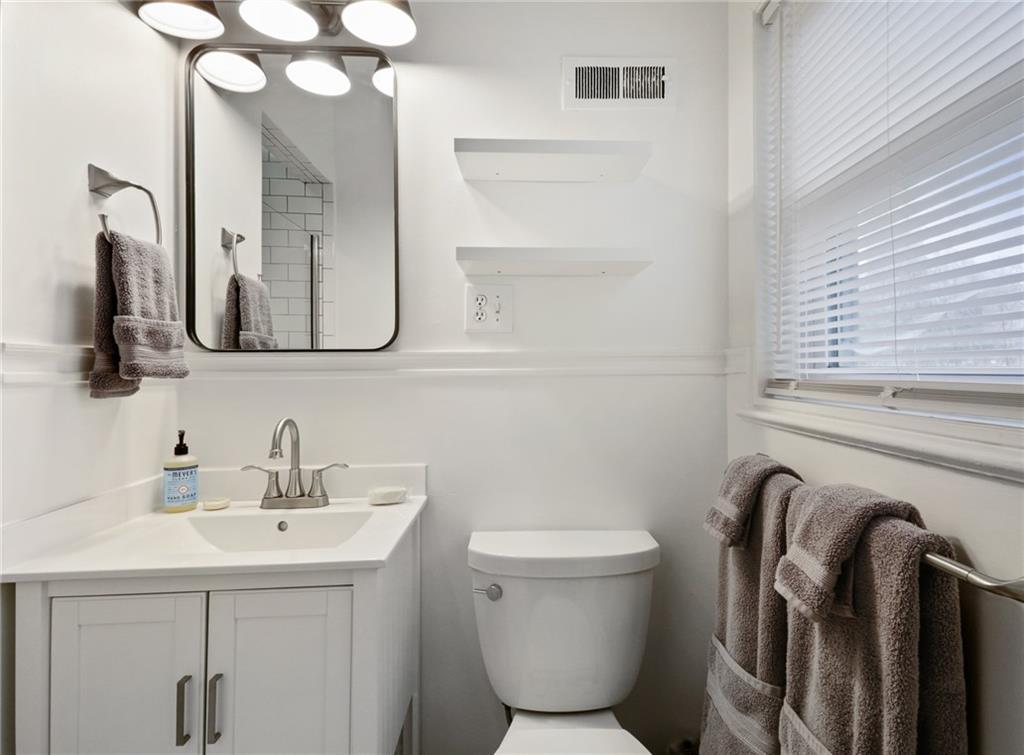 961 East Rock Springs Road Northeast, Unit MODERN Atlanta, GA 30306 - Photo 25 of 47 a bathroom with a toilet sink and mirror