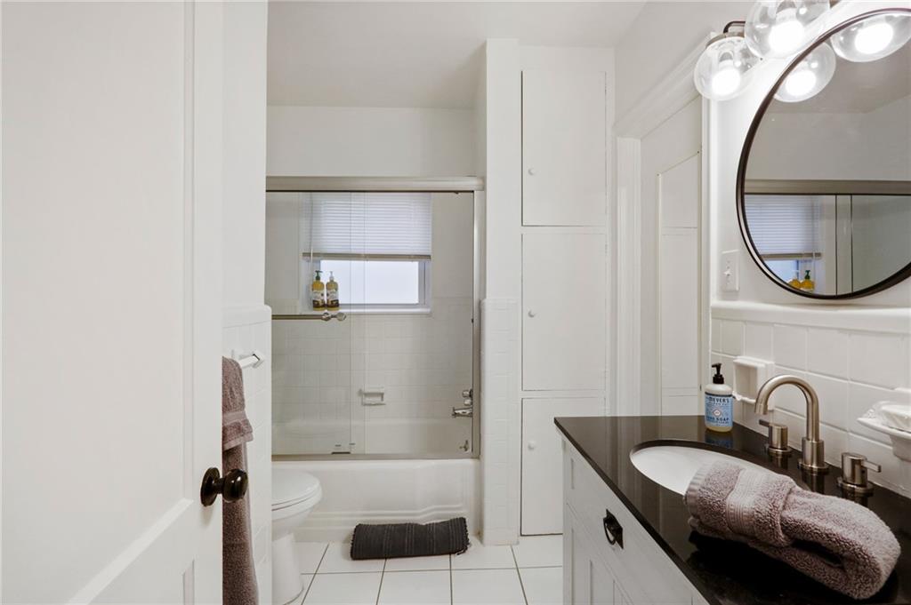 961 East Rock Springs Road Northeast, Unit MODERN Atlanta, GA 30306 - Photo 31 of 47 a bathroom with a granite countertop sink and a mirror