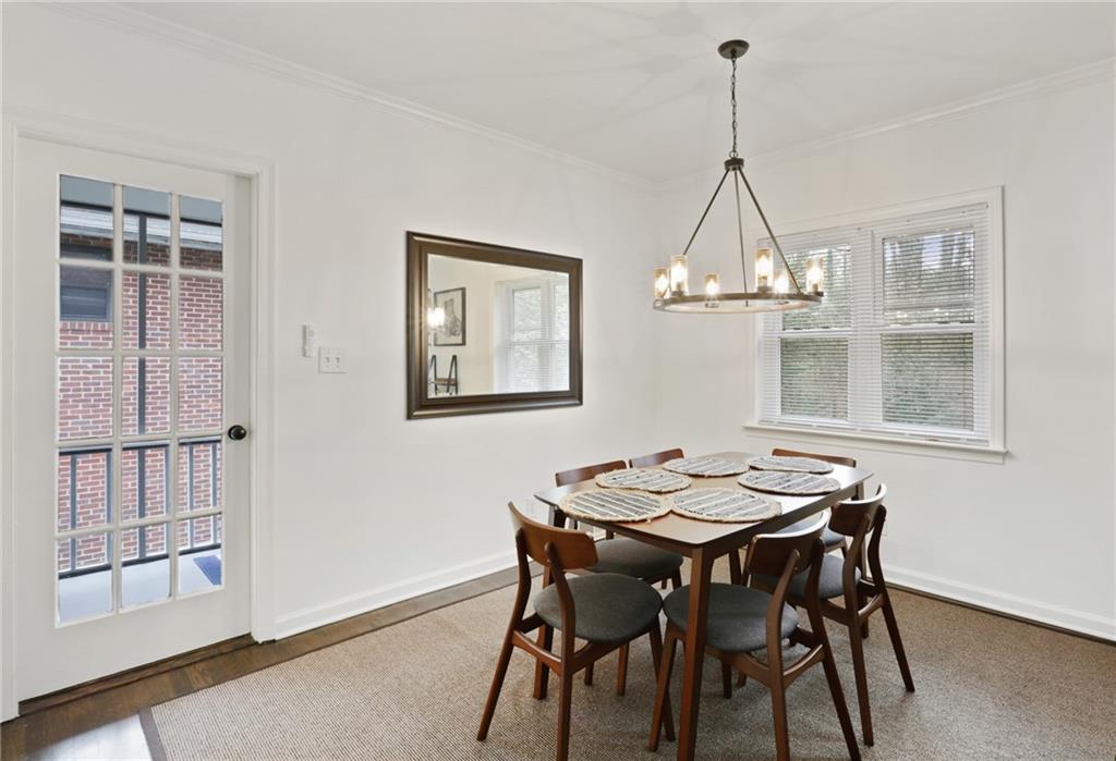 961 East Rock Springs Road Northeast, Unit MODERN Atlanta, GA 30306 - Photo 9 of 47 a view of a dining room with furniture window and wooden floor