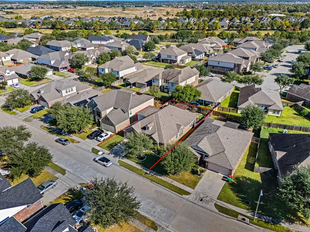 an aerial view of residential houses with outdoor space