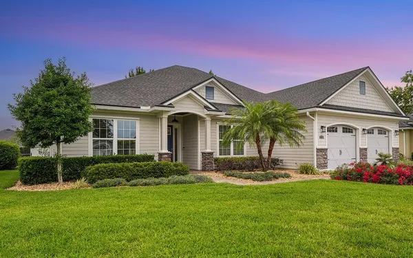 a front view of a house with a garden